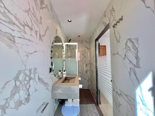 uma casa de banho com um lavatório e um espelho em Villa Alambra Marrakech sur Atlas, Piscine privée em Marrakech