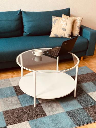 a coffee table with a laptop on top of a couch at NP Hotel Königshof in Dortmund