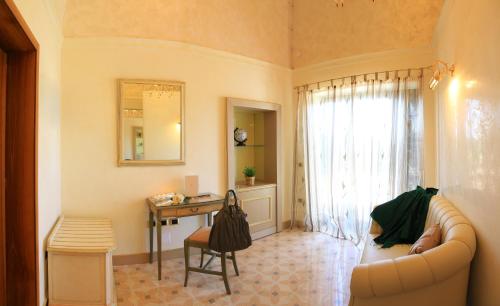 a living room with a couch and a table at Villa Rosa Antico Dimora Storica in Otranto