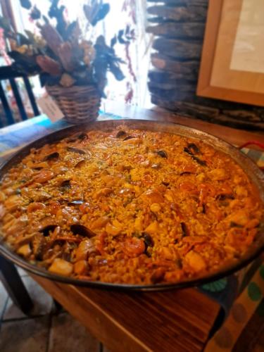a large pizza sitting on top of a table at Hotel Rural La Encantada en Riaza in Becerril