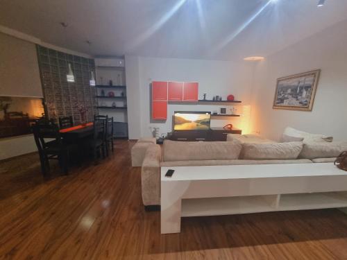 a living room with a couch and a table at Grand Central Apartment LTH in Tirana