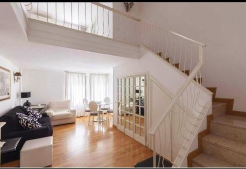 a living room with a staircase and a couch at Apartment luxury Archimede 80 in Rome