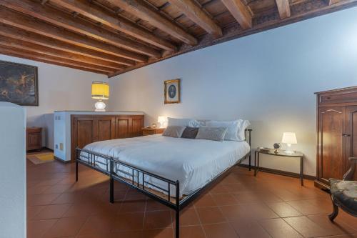 a bedroom with a bed and a wooden ceiling at San Gregorio Magno Apartment in Ferrara