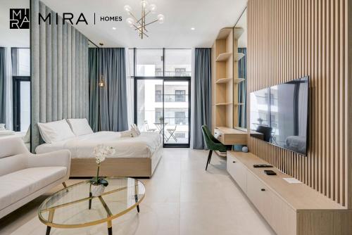 a hotel room with a bed and a tv at Mira Holiday Homes-Cozy studio close to metro in Dubai