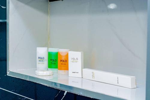 a shelf in a bathroom with some products on it at Polo Grand Hotel in Maiduguri