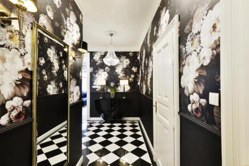 a bathroom with a black and white checkered floor at Broadway Residence in Budapest