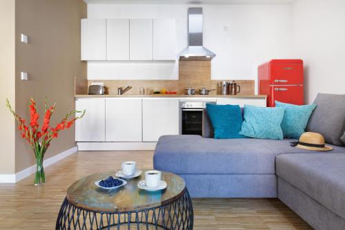 a living room with a couch and a table at Elflein Quartier in Potsdam