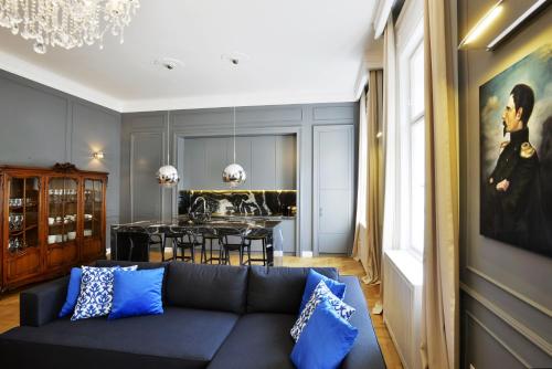 a living room with a couch and a dining room at Broadway Residence in Budapest