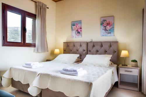 a bedroom with two beds with towels on them at Villa Skala View in Skala Kefalonias