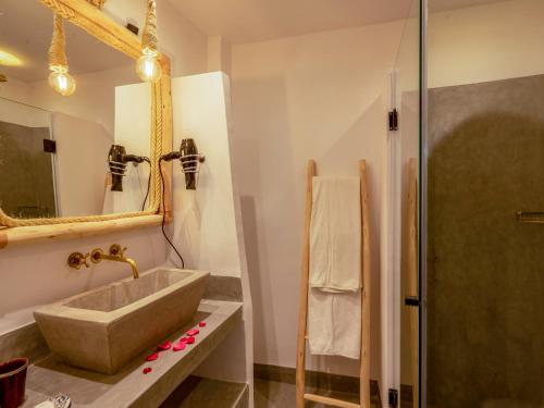 a bathroom with a sink and a shower at Riad Nelia De Marrakech Hotel Boutique & Spa in Marrakech