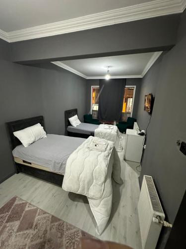 a bedroom with two beds in a room at REYNA OTEL in Yıldırım