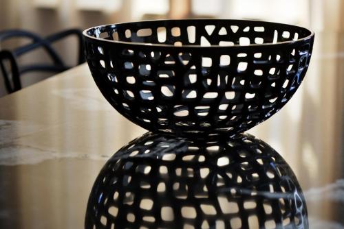 a black vase sitting on top of a table at Broadway Residence in Budapest