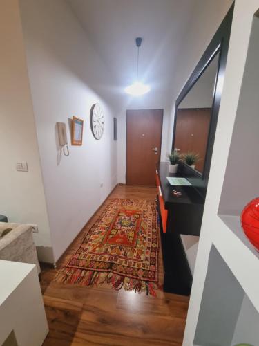 a hallway with a door and a rug at Grand Central Apartment LTH in Tirana