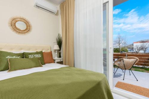 a bedroom with a bed and a sliding glass door at Zefyros Apartments in Skala Rachoniou