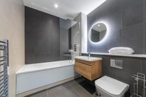 Contemporary 1 Bedroom Apartment in East Grinstead في إيست غرينستيد: حمام مع حوض ومرحاض ومغسلة