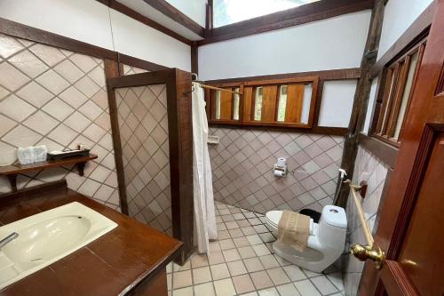 a bathroom with a sink and a toilet at Phu Ing Fah Resort in Chiang Mai