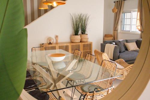 a living room with a glass table and chairs at Quinta do Lago Golfside Retreat in Quinta do Lago