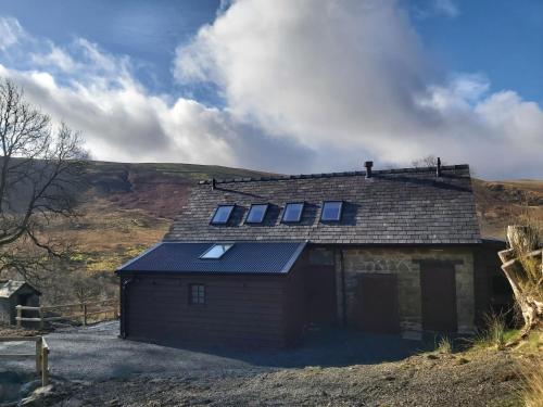 a small house with solar panels on top of it at Cwm Clyd - Carthouse in Rhayader