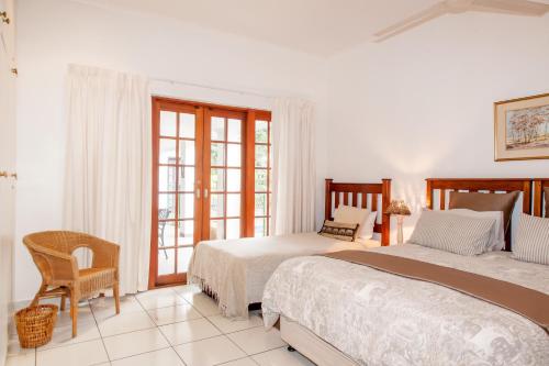 a bedroom with two beds and a window at Rivendell Bed and Breakfast in Hillcrest