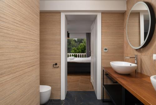 a bathroom with a sink and a mirror at Villa Suartini Viganj Pool or Jakuzzi in Viganj