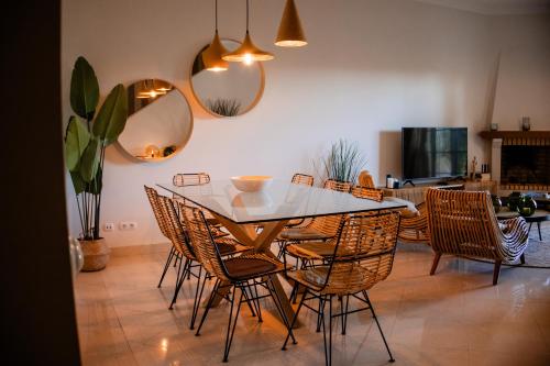 a dining room with a table and chairs at Quinta do Lago Golfside Retreat in Quinta do Lago