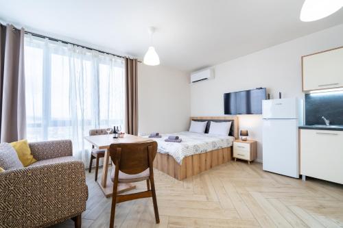 a small room with a bed and a table at WOW studios for rent 2 bul Montevideo 25A - B in Sofia