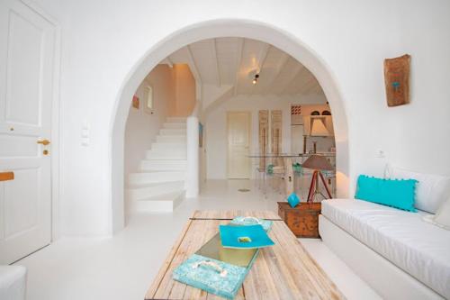 a living room with a couch and a table at Azure Horizon Suites & Villas - Mykonos in Agios Ioannis Mykonos