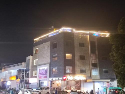 a building with lights on top of it at night at Hotel Mani Ram Palace,Agra in Agra