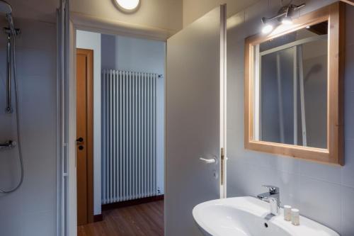 a bathroom with a sink and a mirror at ALLE ANTICHE MINIERE - CASA VACANZE in Zenich