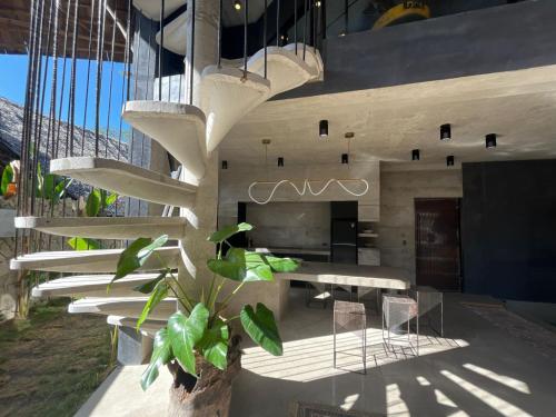 a staircase in a building with a table and chairs at Happiness Kulambo Villa El Nido in El Nido