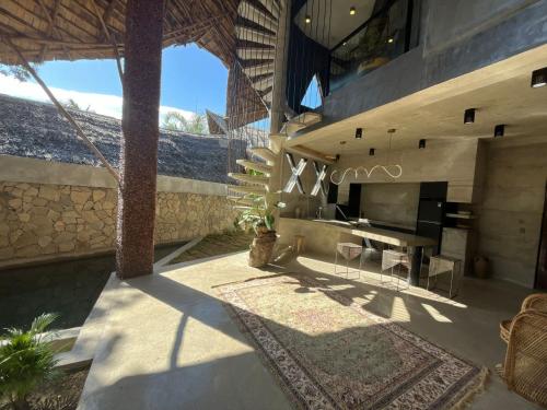 a patio with a table and a fireplace in a house at Happiness Kulambo Villa El Nido in El Nido