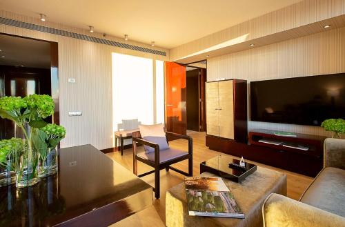 a living room with a couch and a table at Hyatt Regency Barcelona Tower in Hospitalet de Llobregat