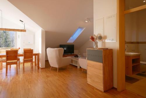 a kitchen and dining room with a table and a dining room at Ferienwohnungen beim Sommermader - inklusive Königscard in Nesselwang
