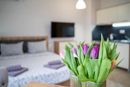 a vase of flowers on a table in a living room at WOW studios for rent - bul Montevideo 25A - B in Sofia
