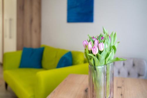 a vase of pink tulips sitting on a table at WOW studios for rent - bul Montevideo 25A - B in Sofia