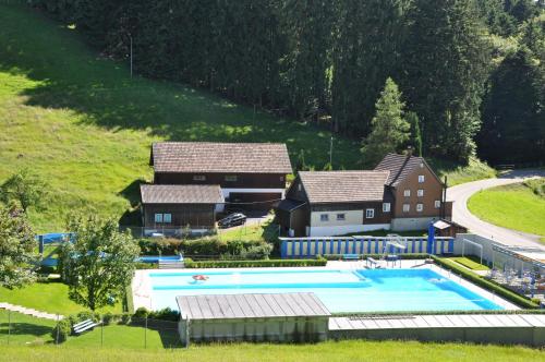 an aerial view of a house and a swimming pool at Gästehaus Eisenhut in Walzenhausen