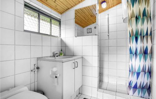 a bathroom with a toilet and a sink at 3 Bedroom Cozy Home In Dannemare in Dannemare