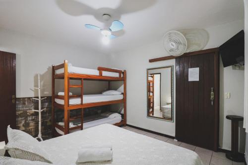 a bedroom with a bunk bed and a mirror at Hostel Cabo Frio in Cabo Frio