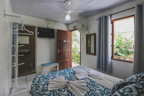 a bedroom with a bed with bows on it at Hostel Cabo Frio in Cabo Frio