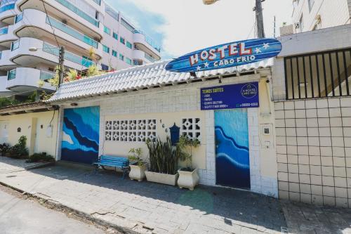 a building with a sign on the side of it at Hostel Cabo Frio in Cabo Frio