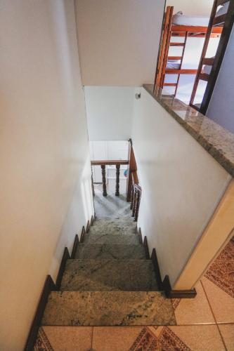 a staircase in a building with a table on it at Hostel Cabo Frio in Cabo Frio