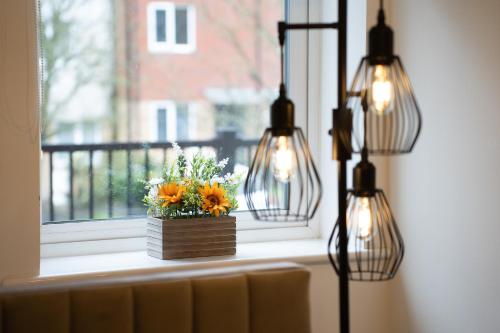 a window with a vase of flowers on a window sill at Open Mind Property - Luxury Apartment Near Hospital & Underground Free Parking for 2 Vehicles in Southampton