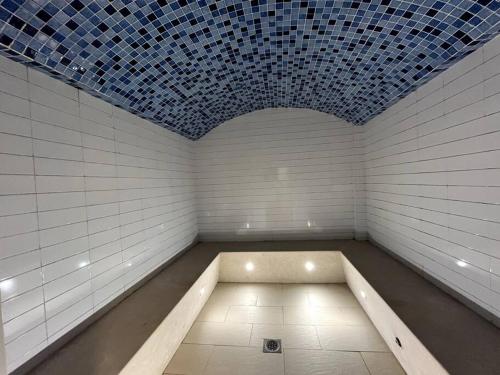 a white room with a blue tile ceiling at Luxury Beachfront Studio Apartment Marjan Island in Ras al Khaimah