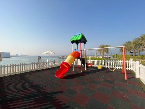 a playground with a slide on the beach at Luxury Seaview Studio Apartment -RAK Marjan Island in Ras al Khaimah