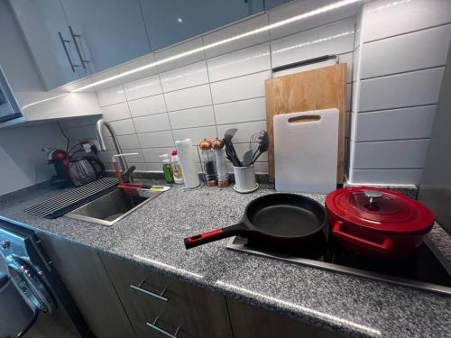 a kitchen counter with a frying pan and a sink at Luxury Seaview Studio Apartment -RAK Marjan Island in Ras al Khaimah