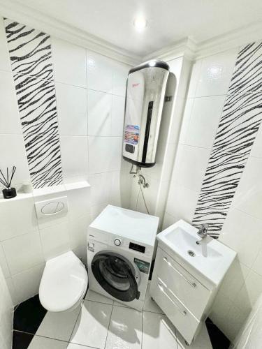 ein weißes Bad mit einem WC und einem Waschbecken in der Unterkunft Modern style Best location in Chişinău