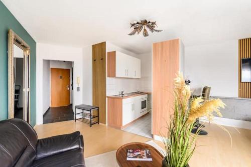 a living room with a couch and a kitchen at Studio Apart - Küche - Balkon - Netflix in Bad Säckingen