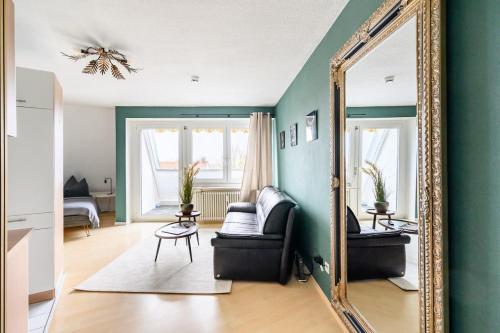 a living room with a mirror and a couch at Studio Apart - Küche - Balkon - Netflix in Bad Säckingen