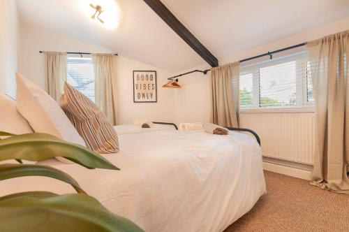 a bedroom with a white bed and a window at The Corner Stop~ Dog Friendly Holiday Let in Plymouth in Plymouth