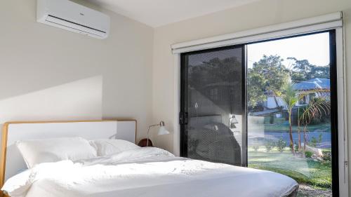 a bedroom with a bed and a large window at Rye's Get Away in Rye